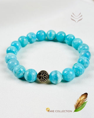 Blue hemimorphite bracelet featuring a tree charm.