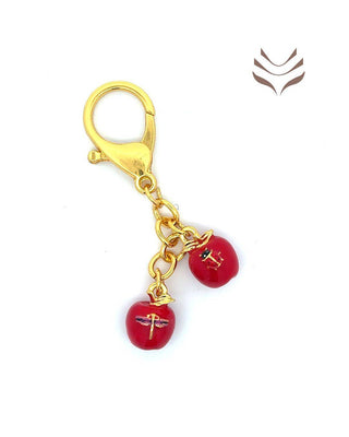 Light-coded apple amulet with ladybug and butterfly charms, gold clasp, promoting harmony and avoiding disputes in feng shui jewelry.