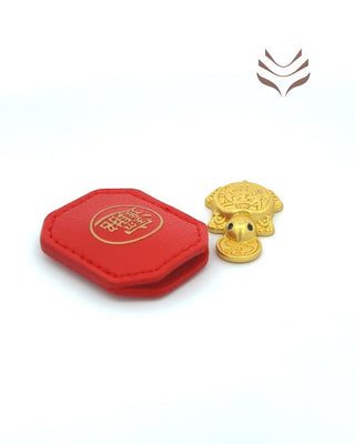 Golden Light-Coded Pocket Tortoise displayed next to a red feng shui pouch, symbolizing prosperity and good health.