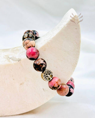 Rhodonite bracelet displayed on a crescent-shaped stand