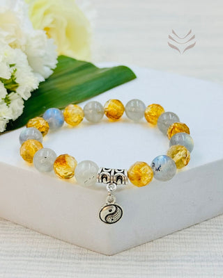 Crystal bracelet with labradorite and citrine stones on display.