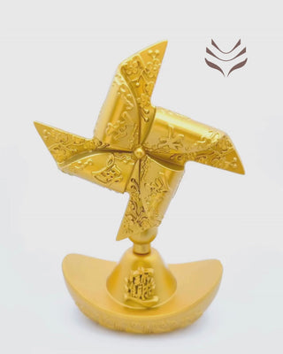 Golden feng shui fan with intricate carvings on a gold ingot base, designed to clear bad luck and attract prosperity.