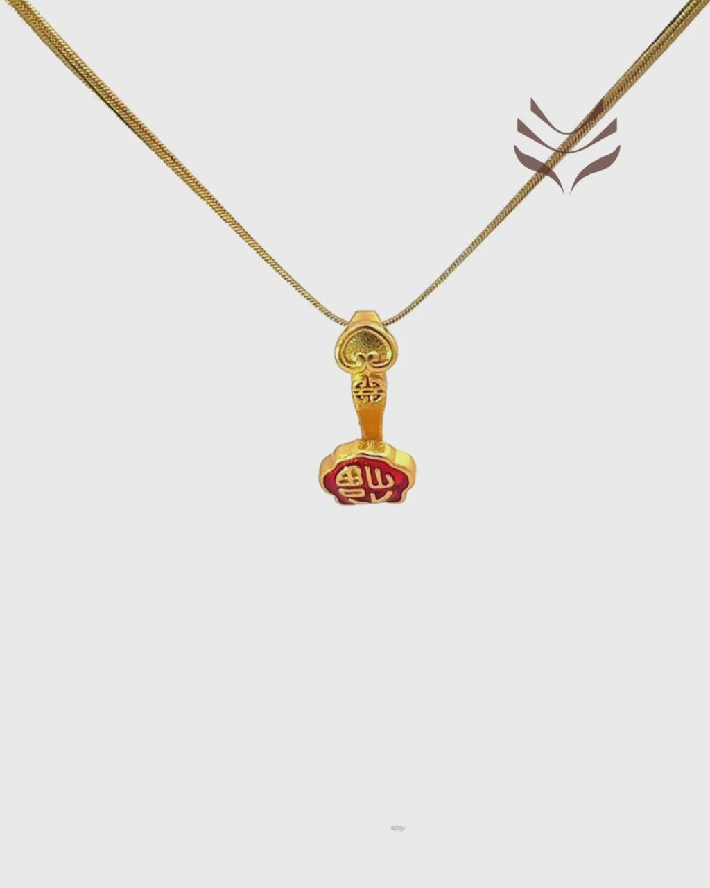 Gold-toned Ru-Yi Stick Pendant with intricate light-coded design and red accents, symbolizing power and authority in Feng Shui.